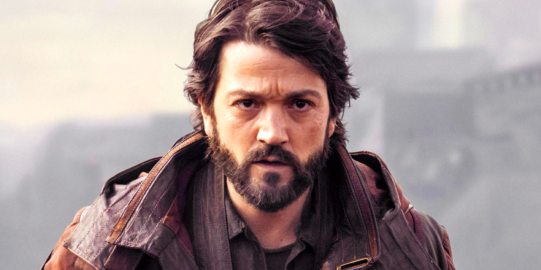 Cassian Andor looks determined as he walks toward camera in Andor.