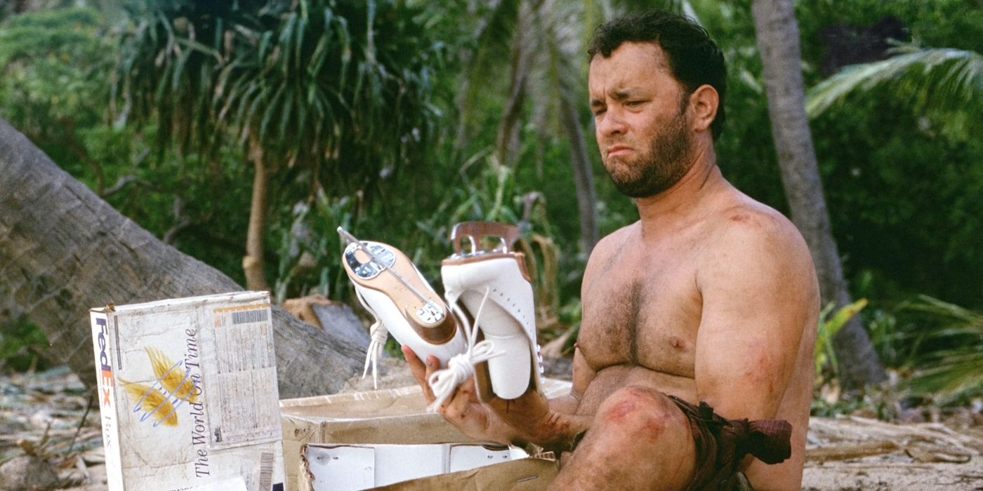 Chuck lookingat a pair of skates while sitting on the beach in Cast Away