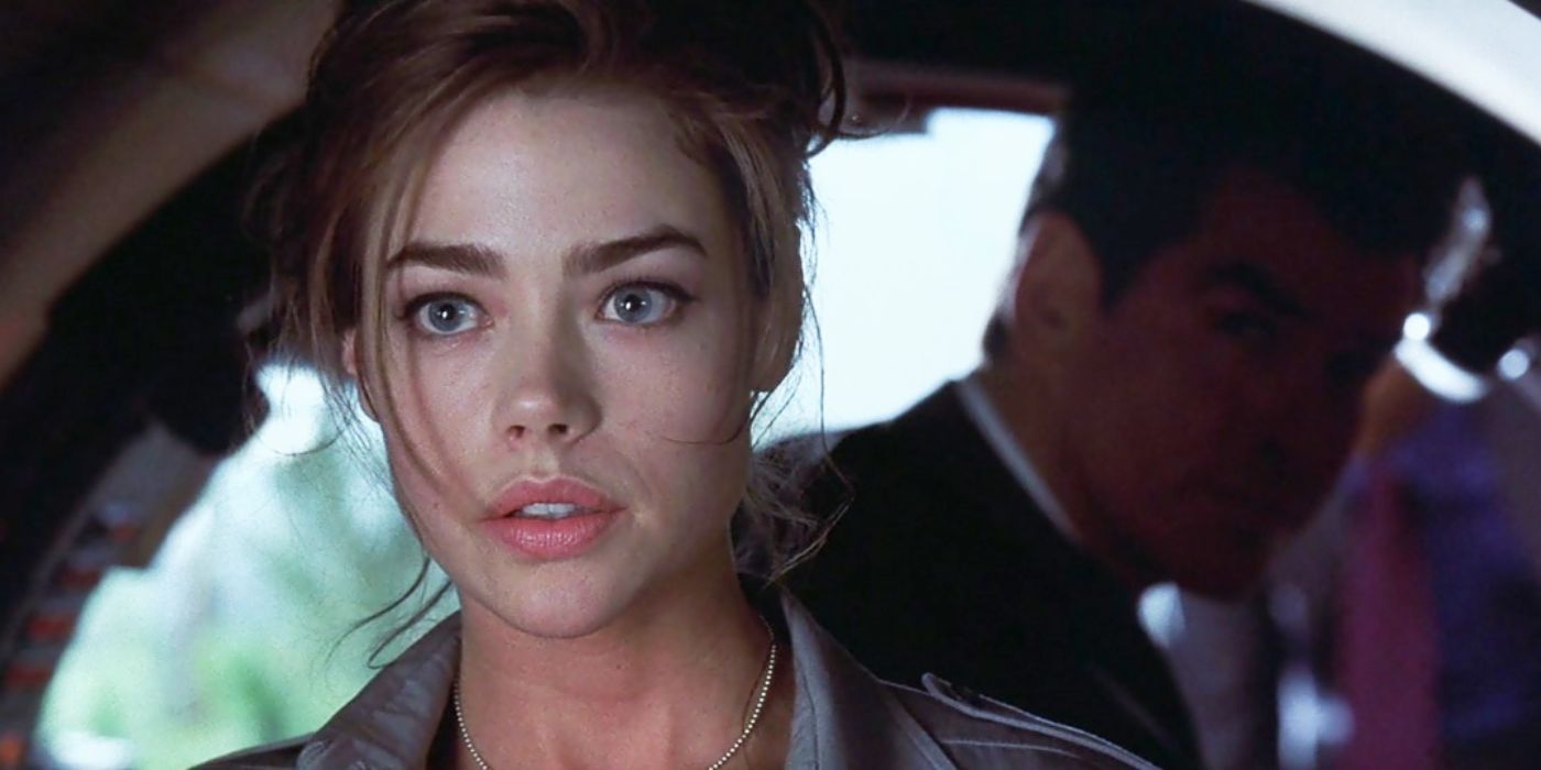 Denise Richards as Christmas jones sitting in a car, with Pierce Brosnan's James Bond behind her 