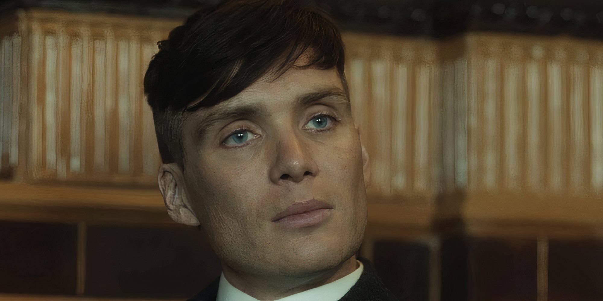 Cillian Murphy as Tommy Shelby with a serious expression in Peaky Blinders.