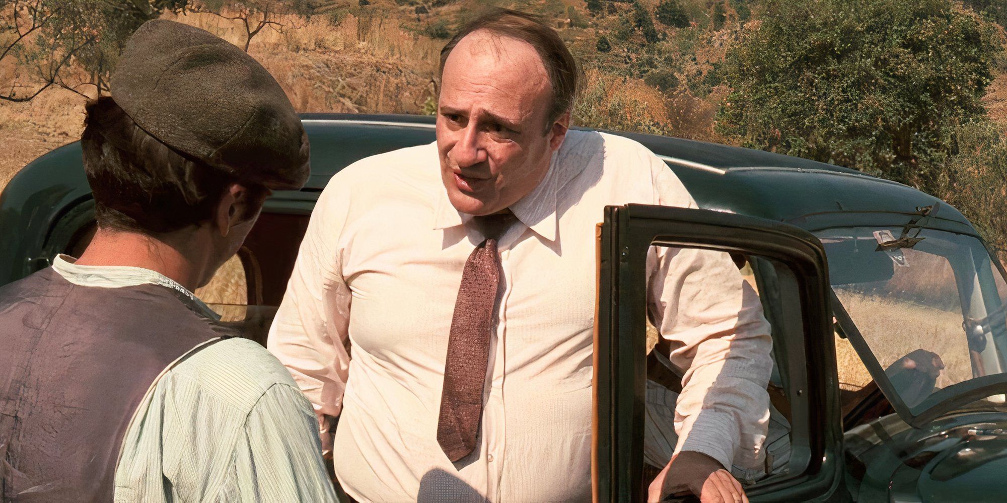 Corrado Gaipa standing outside a car talking to Al Pacino in The Godfather (1972)