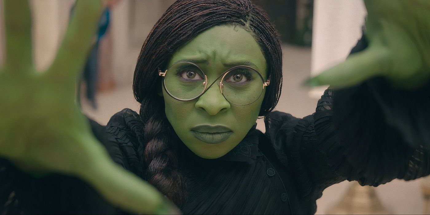 Cynthia Erivo as Elphaba pushing her hands out while wearing glasses in Wicked.