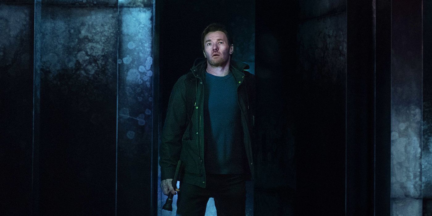 Joel Edgerton as Jason Dessen stepping out of a large box with a bag in Dark Matter.