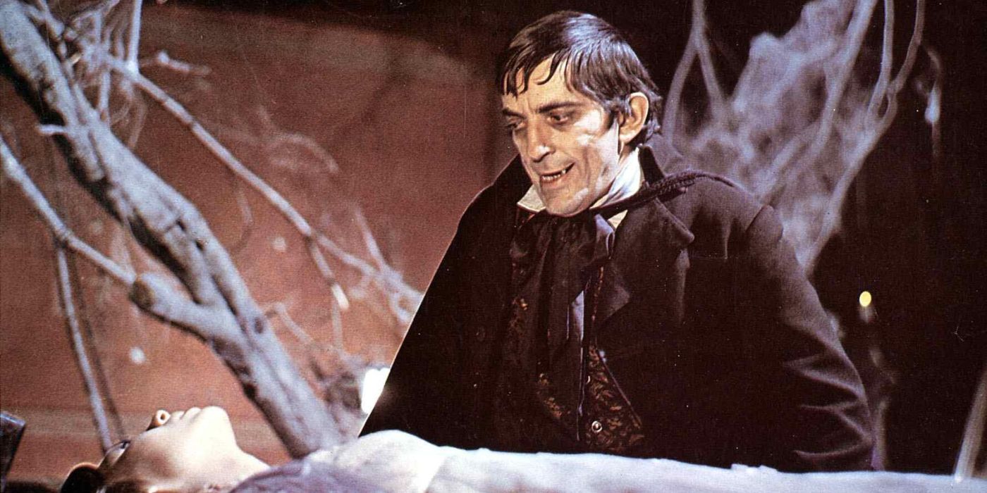 Barnabas Collins (Jonathan Frid) staring down with bared fangs at an unconscious woman lying on her back on a table in Dark Shadows