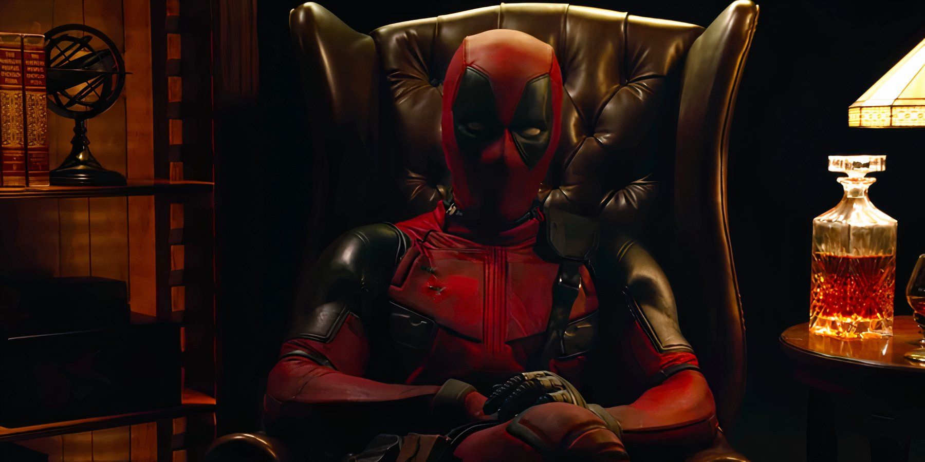 Masked vigilante Deadpool sits in a leather armchair and looks directly into the camera in a teaser trailer for 2016’s Deadpool.