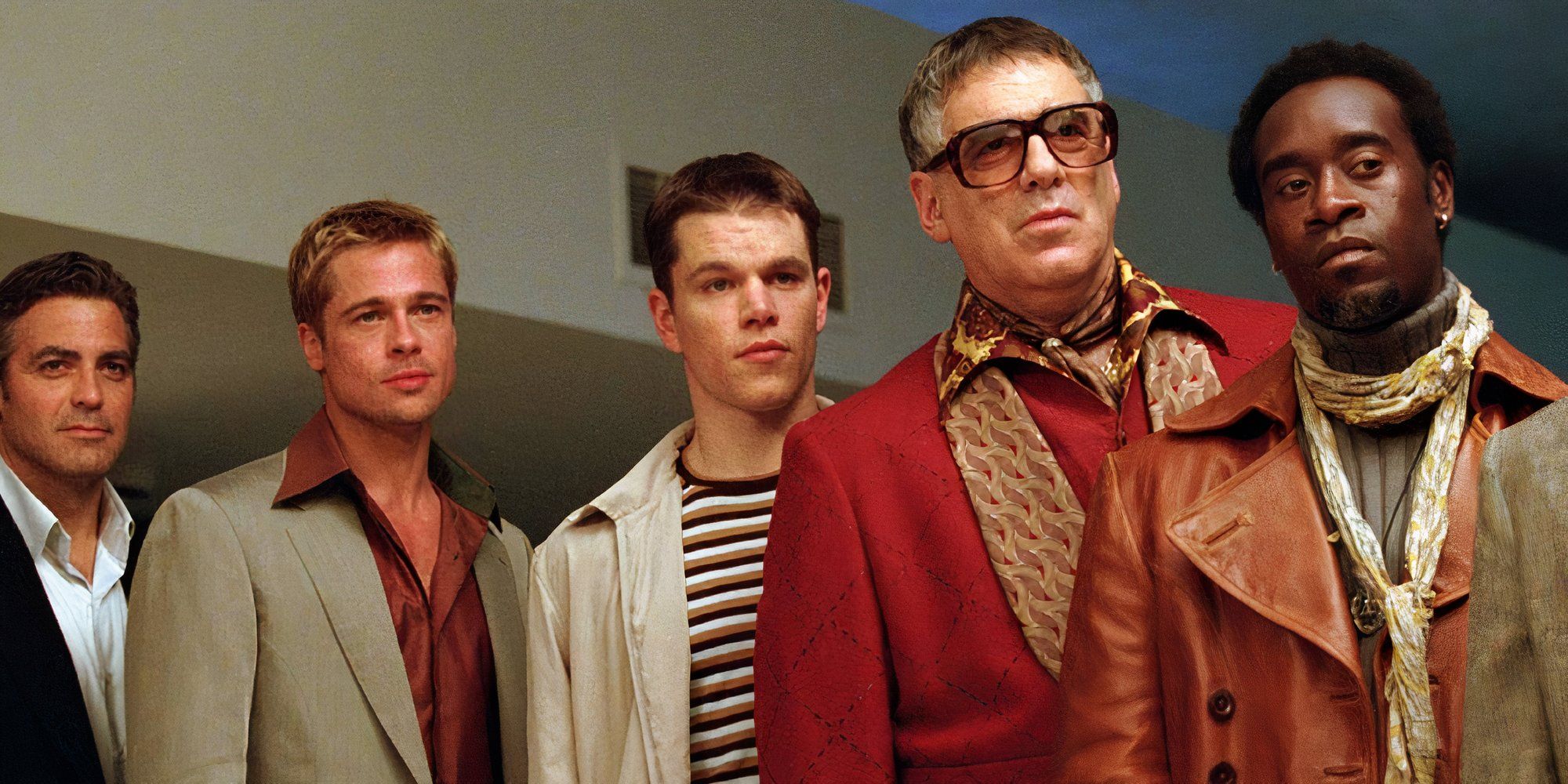 The cast of Ocean's Eleven standing in line and looking in the same direction.