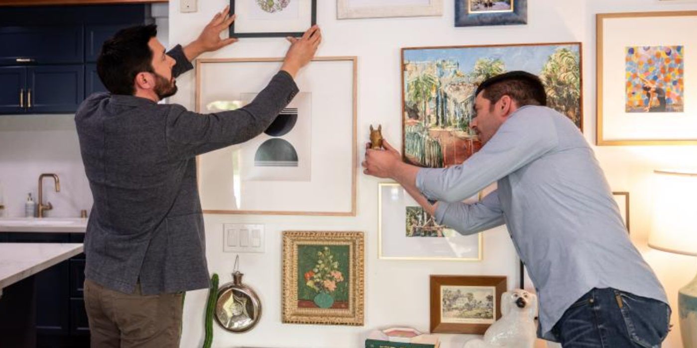 Drew Scott and Jonathan Scott, stars of HGTV's 'Backed By The Bros', hanging up wall decorations