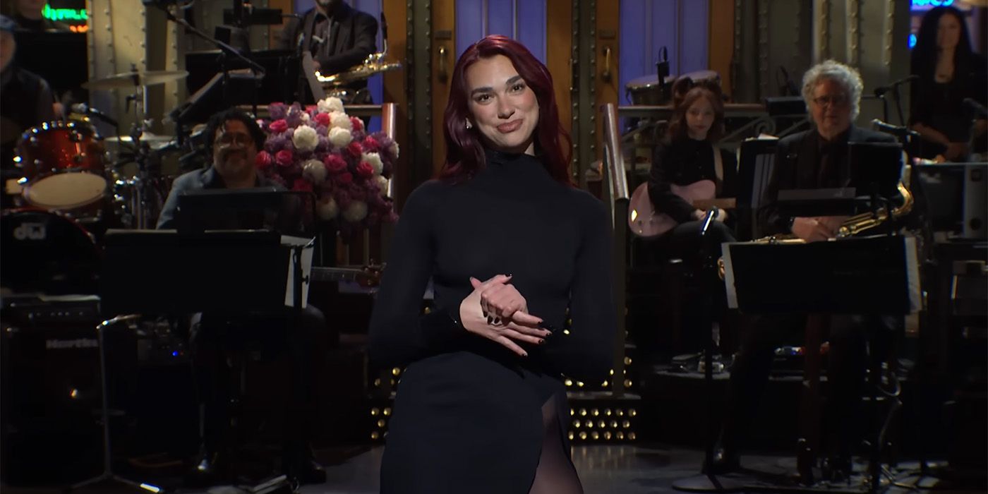 Dua Lipa giving her opening monologue on SNL in all black