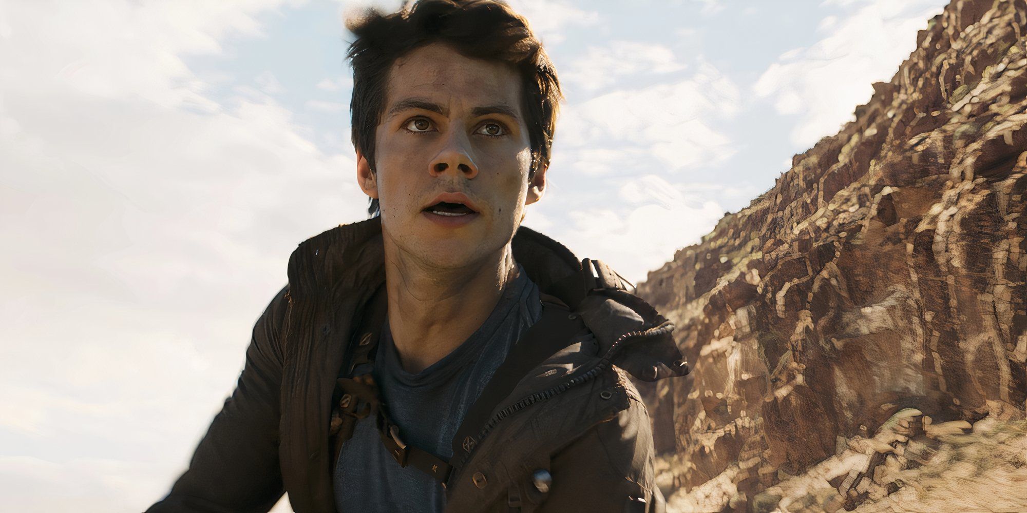 Thomas in Maze Runner The Death Cure looking scared in a mountainous desert