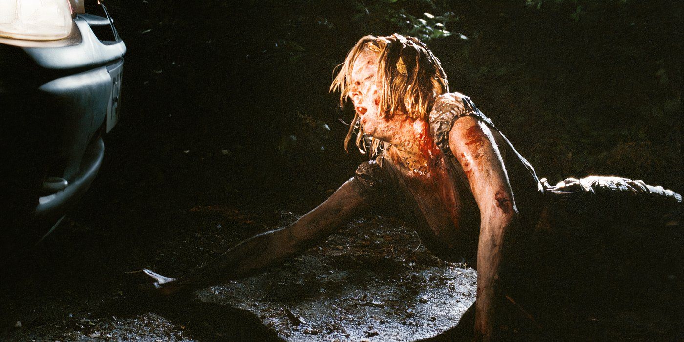 A bloodied Kelly Reilly in Eden Lake looks terrified as she lies on the street. 