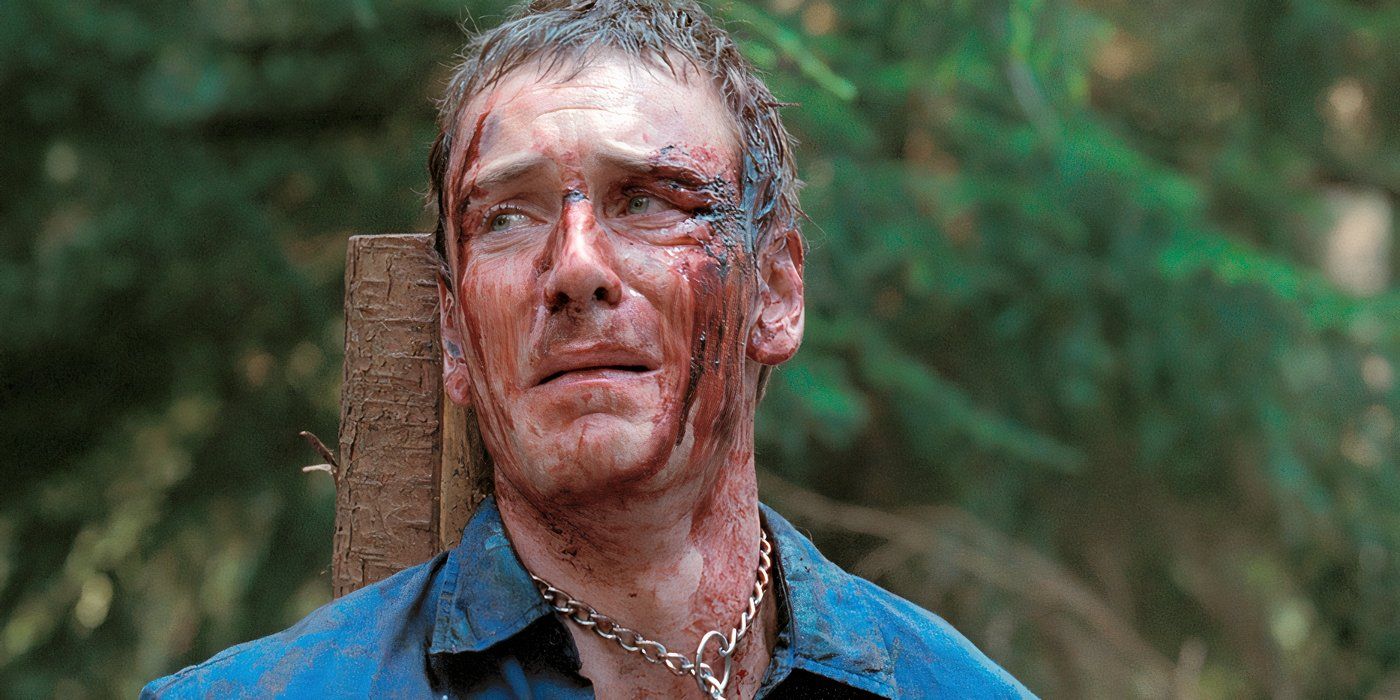 A bloodied Michael Fassbender in Eden Lake looks terrified as he's bound to a pole. 