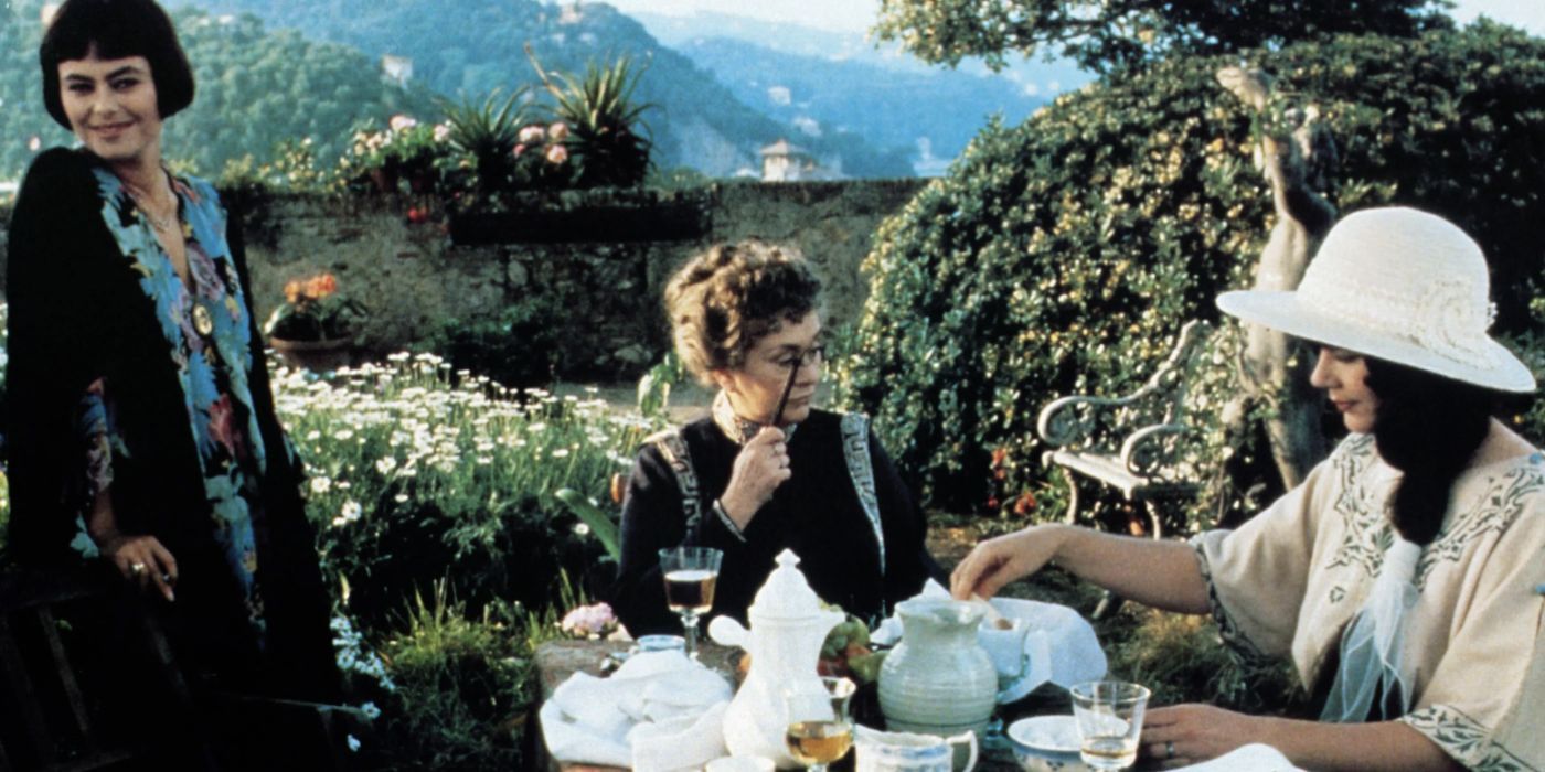 Three women having tea outside in Enchanted April 1991