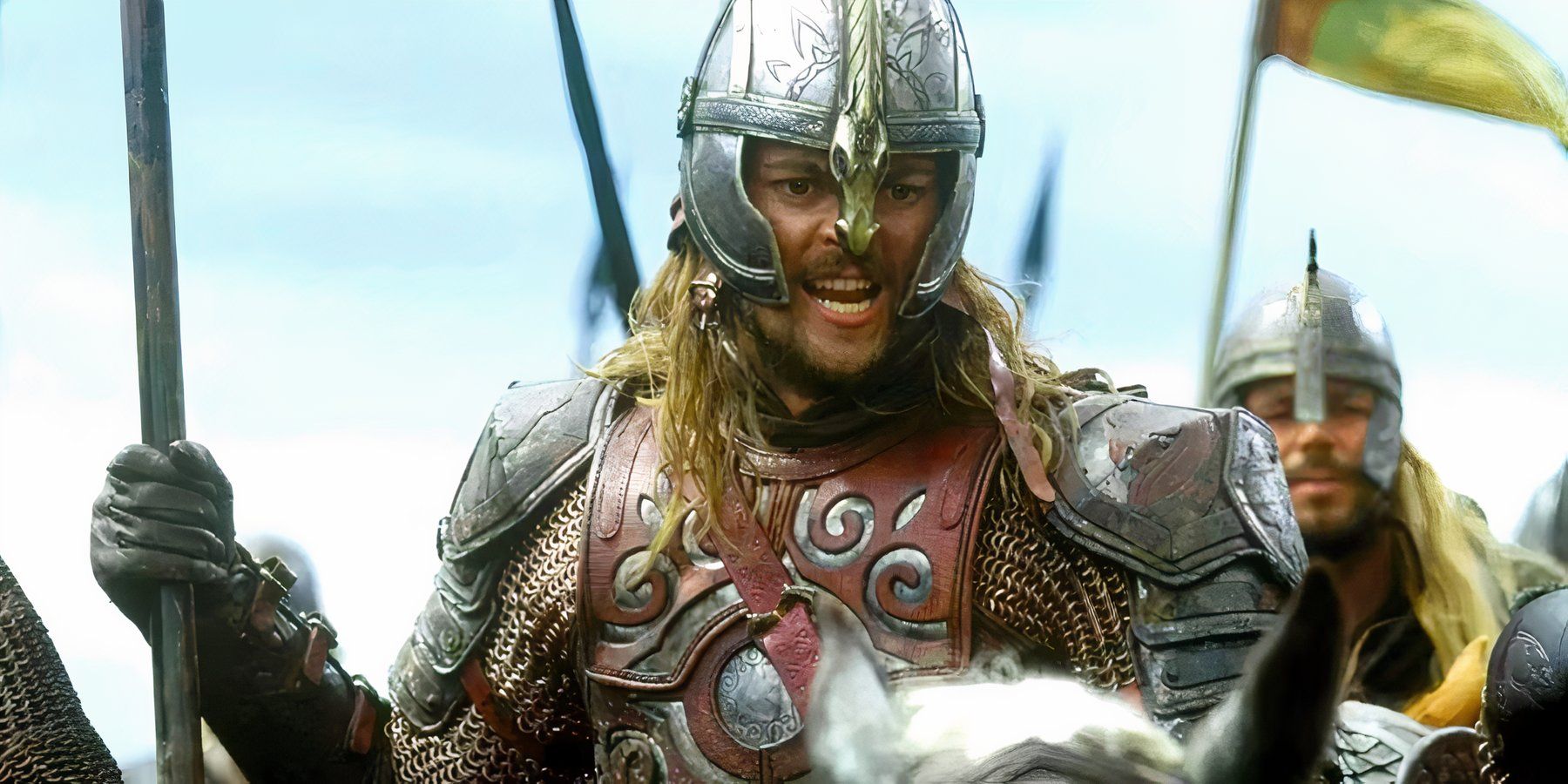 Éomer, played by Karl Urban, rides on horseback, clad in Rohan armor in The Lord of the Rings: The Two Towers.