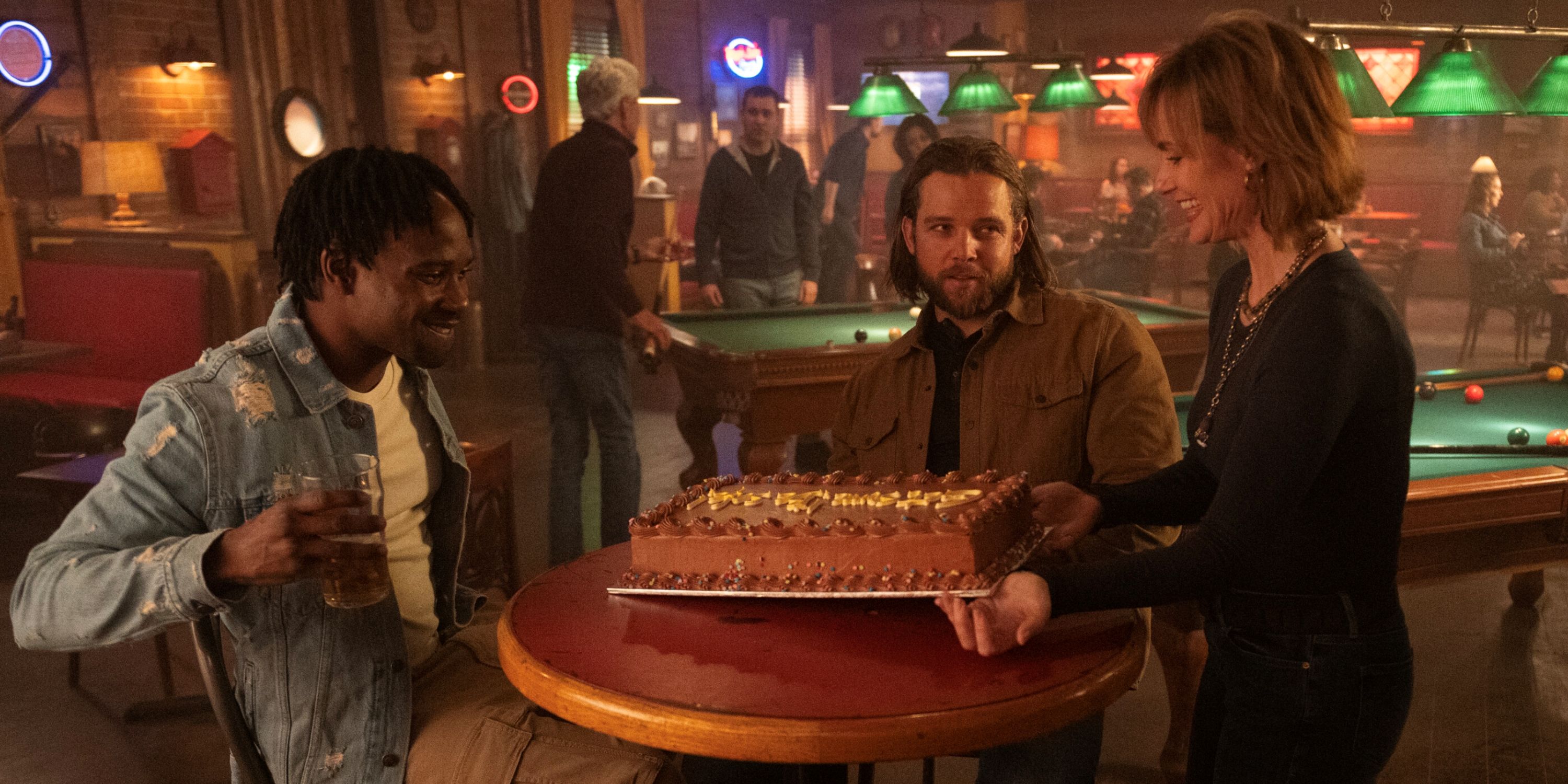 Max Thieriot as Bode in a bar with his mom and his friend Freddy in Episode 10 of Season 2 of Fire Country