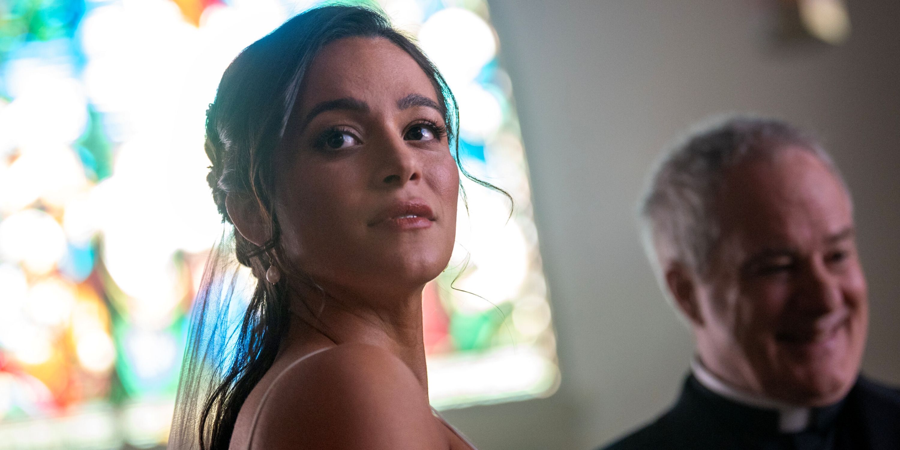 Stephanie Arcila as Gabriela with the priest at the chapel for her wedding in Season 2 of Fire Country