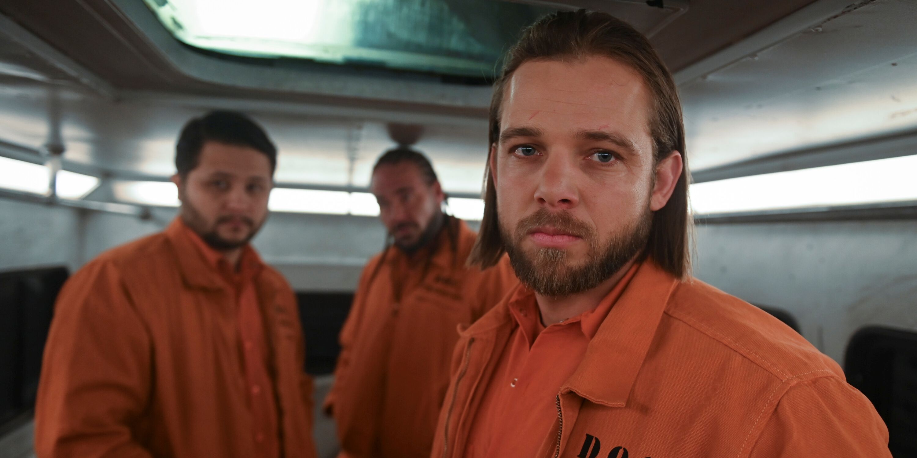 Max Thieriot as Bode Leone in his orange jumpsuit at inmate fire camp in Episode 8 of Season 2 of Fire Country