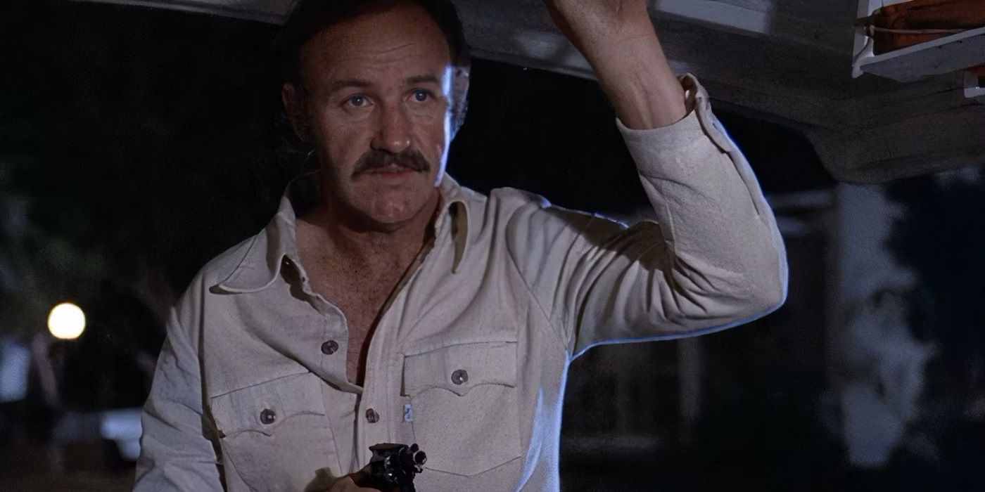 Harry Moseby pointing a gun in a white shirt at night in 'Night Moves'