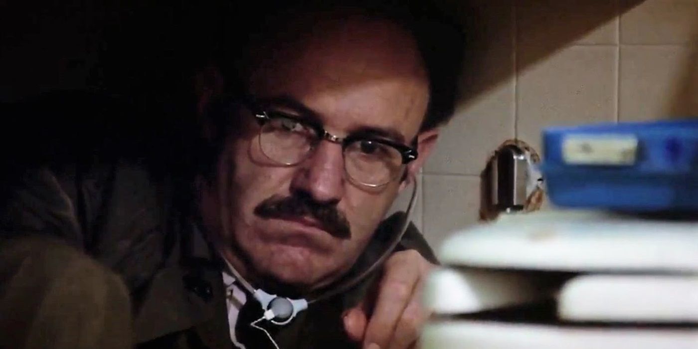 Gene Hackman as Harry sitting beside a toilet in The Conversation