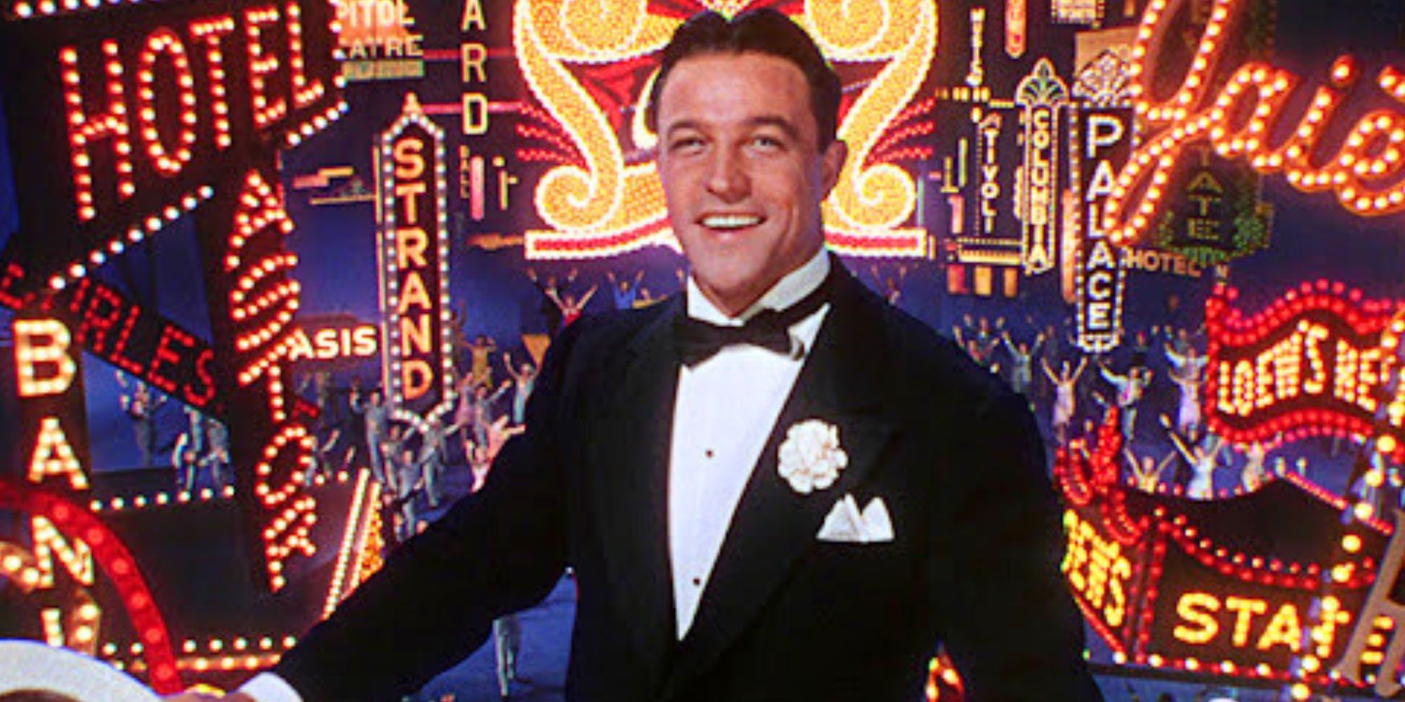 Gene Kelly as Don Lockwood stands in front of an illuminated sign in Singin' in the Rain (1952)