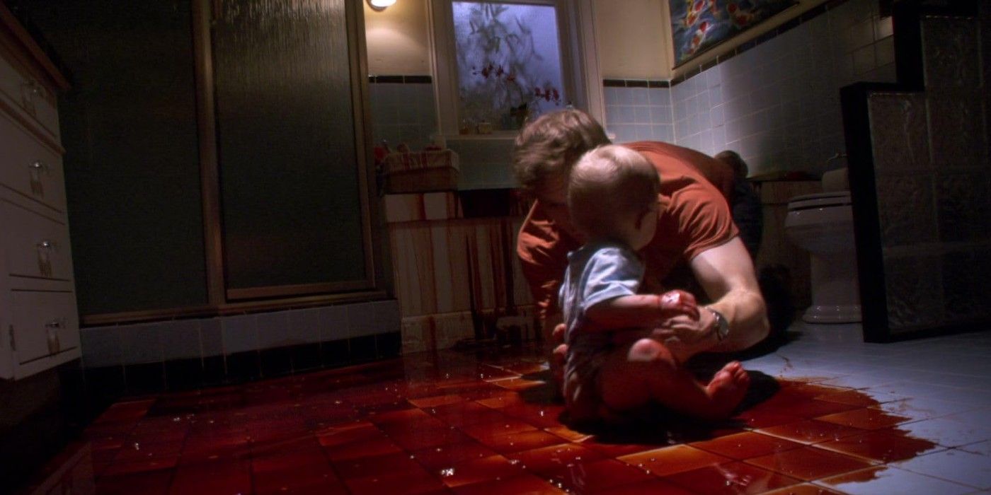 Dexter runs to Harrison who sits in a pool of blood in the bathroom
