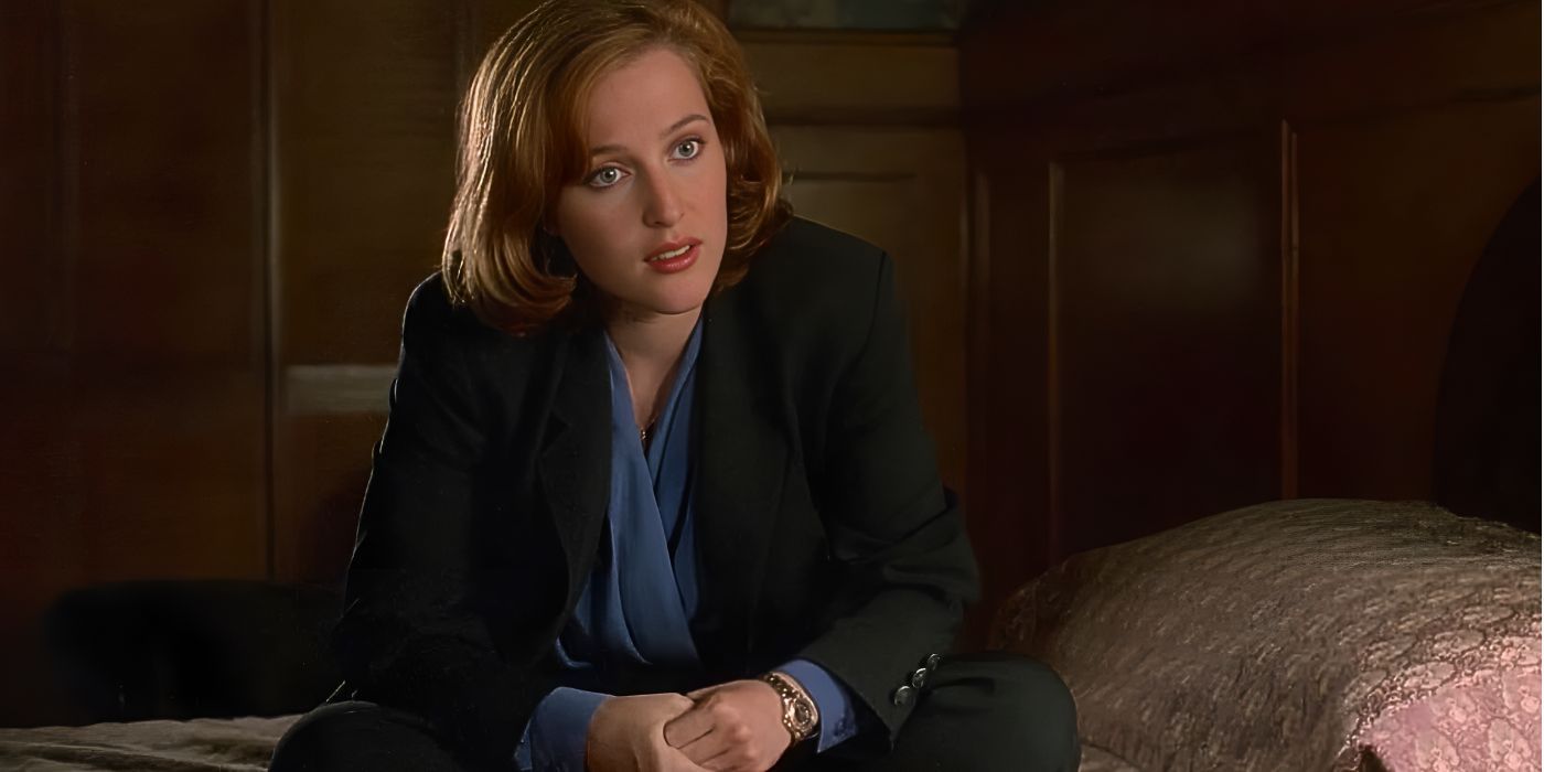 Gillian Anderson sits cross-legged on hotel bed as she looks at off-screen Peter Boyle from the episode Clyde Bruckmans Final Repose in The X-Files