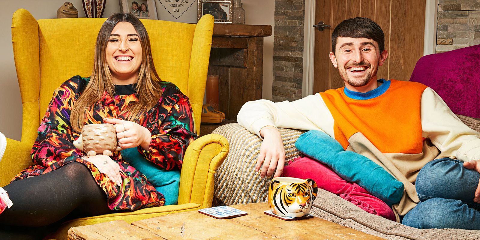 Pete and Sophie smiling and watching the television in Gogglebox