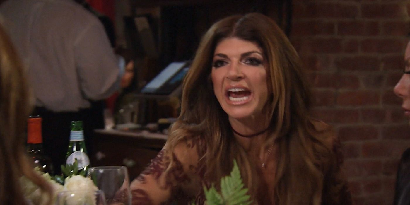 Teresa Giudice at a dinner table yelling at the person in front of her
