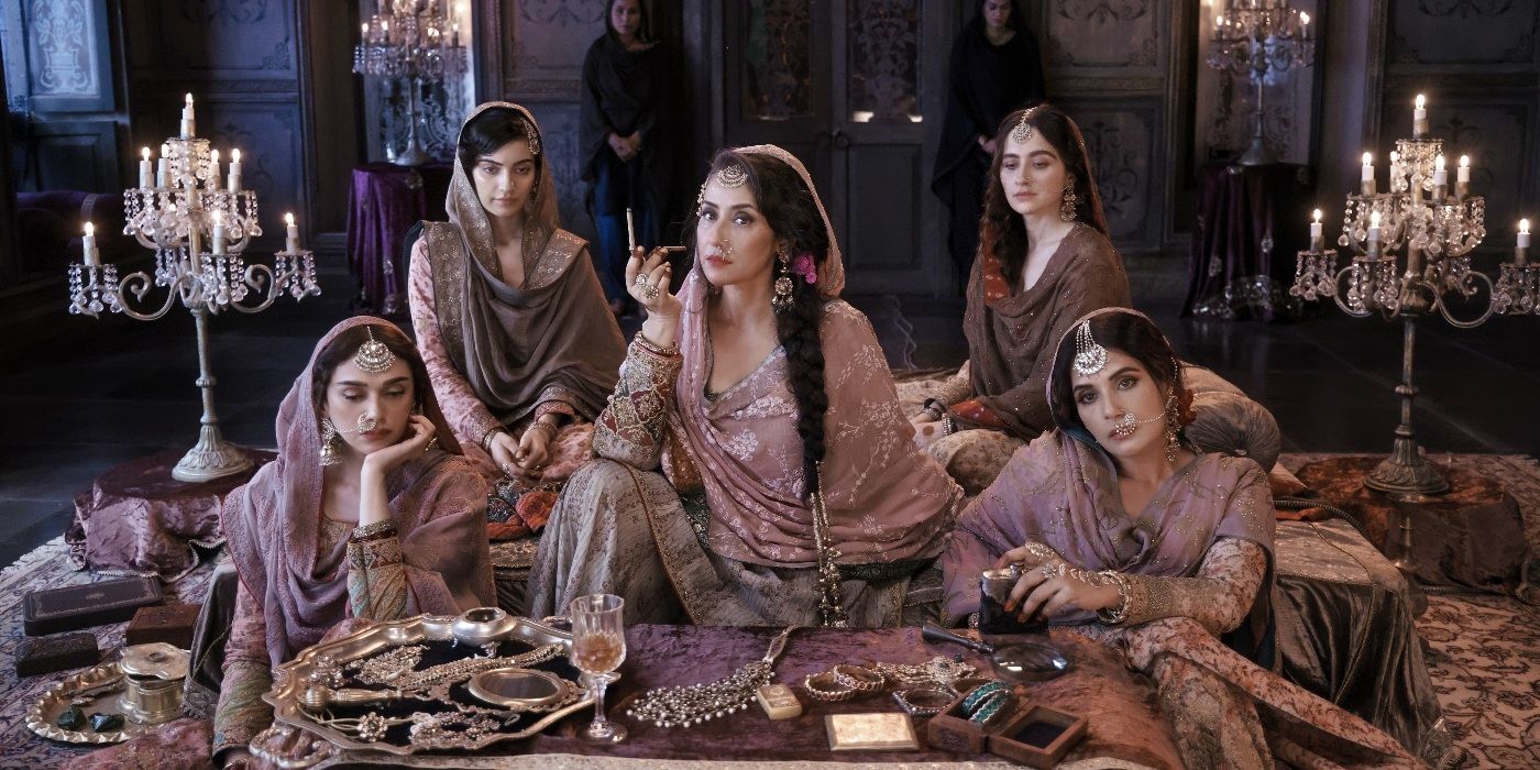 The cast of Heeramandi: The Diamond Bazaar sitting on a dais in the Netflix series