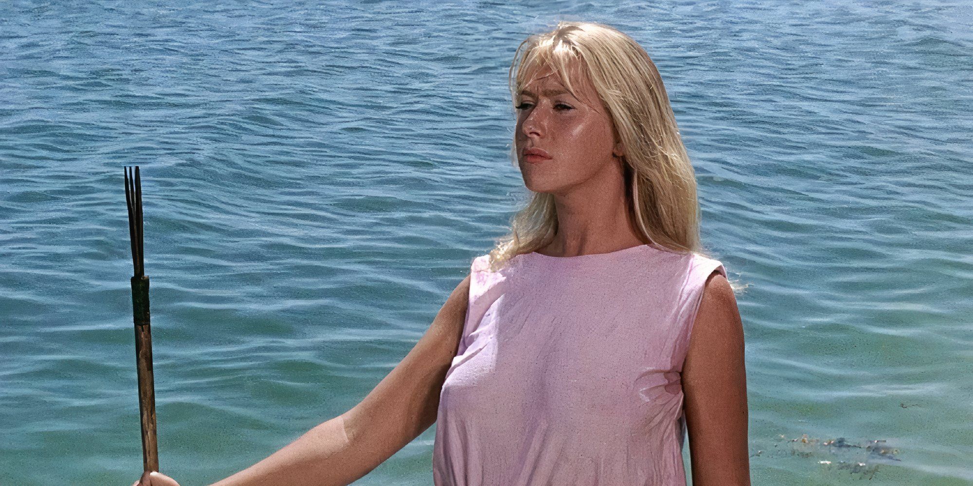Helen Mirren as Cora Ryan holding a stick near the ocean in Age of Consent.