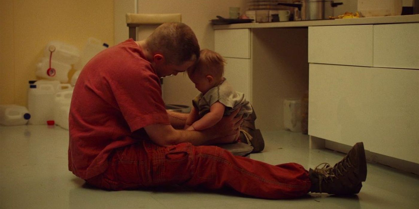 Monte (Robert Pattinson) playing with his baby daughter Willow (Scarlett Lindsey) in High Life
