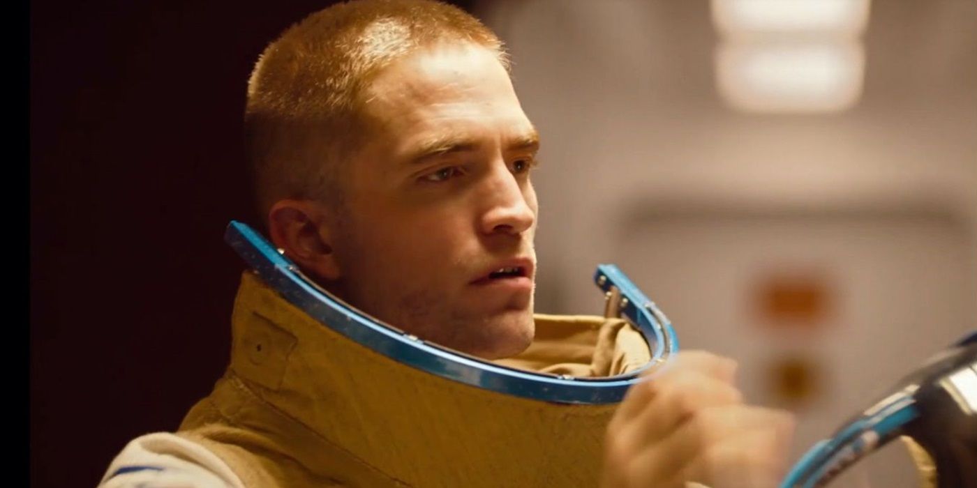 Monte (Robert Pattinson) in his space suit, looking at an object offscreen, in High Life