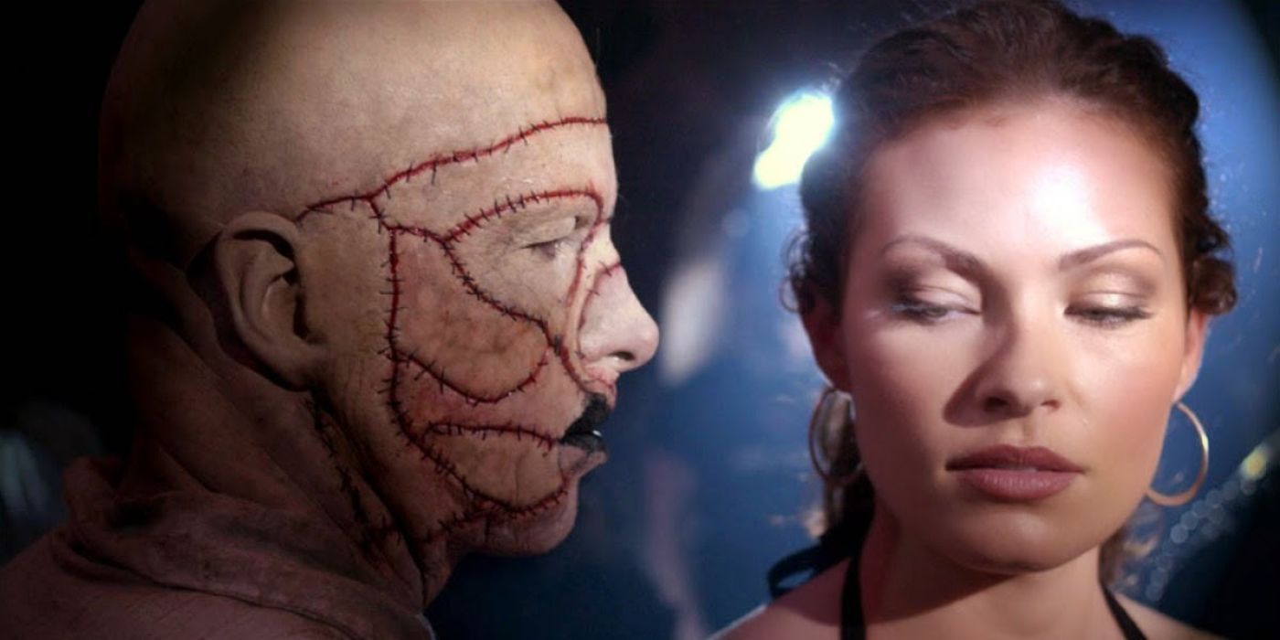 A man with scars on his face approaches a scared-looking woman in House of the Dead