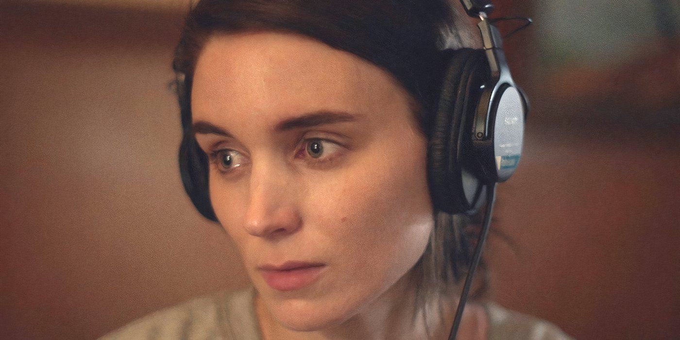 Rooney Mara as M with her headphones on as she looks off into the distance in A Ghost Story
