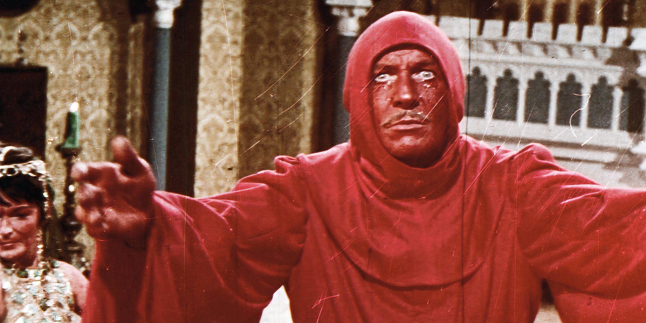 Prince Prospero spreading his arms and looking intently ahead in The Masque of the Red Death