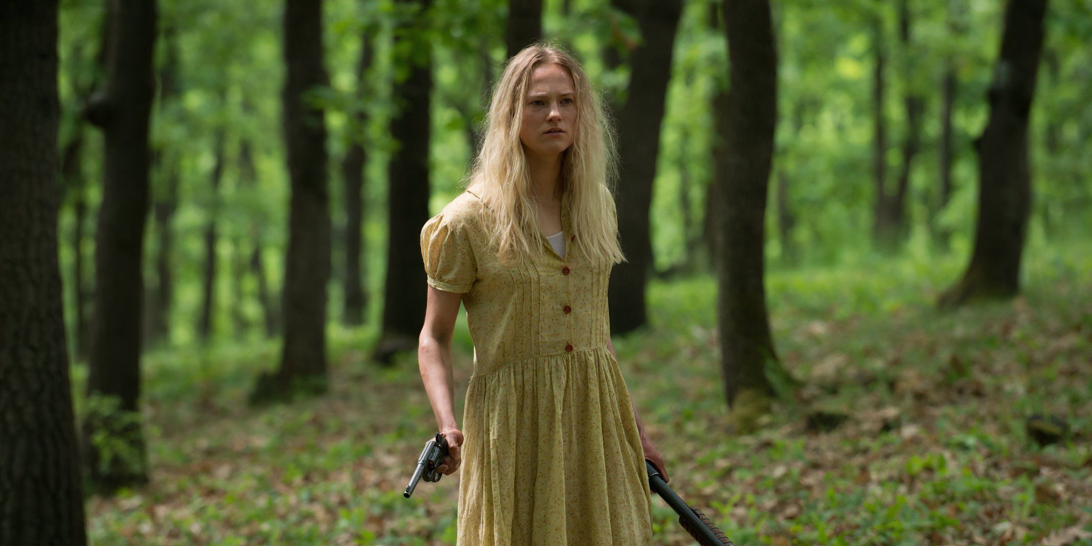 Jessica Madsen as Clarice holding guns in forest in Leatherface.