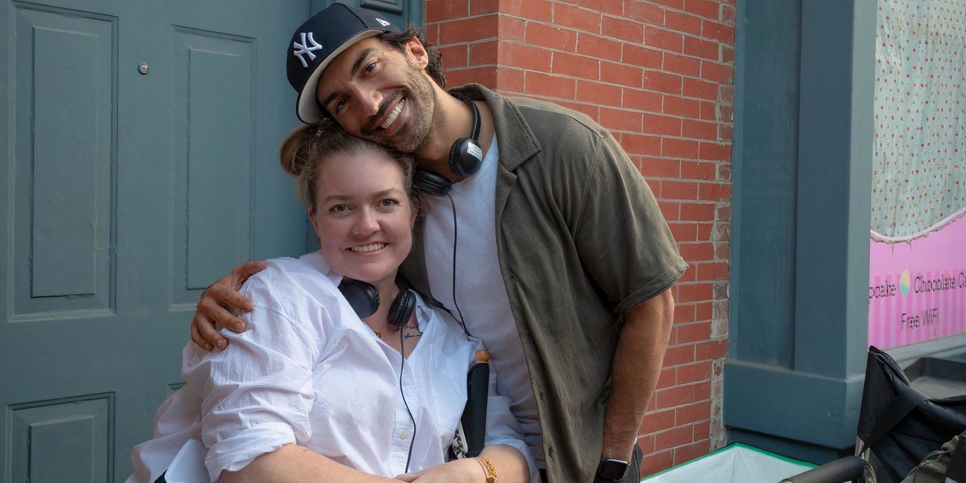 Colleen Hoover and Justin Baldoni smiling and leaning into one another in It Ends With Us.
