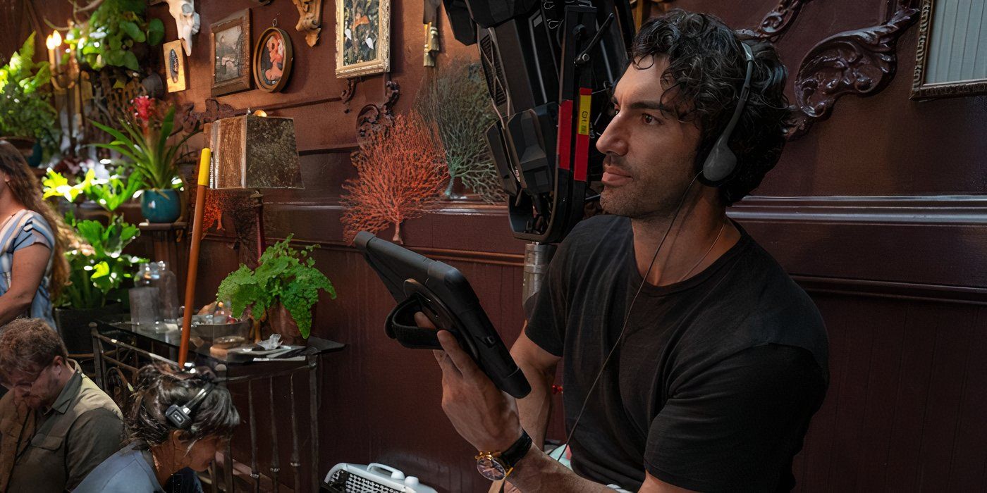 Justin Baldoni holding a tablet and wearing headphones on the set of It Ends With Us.