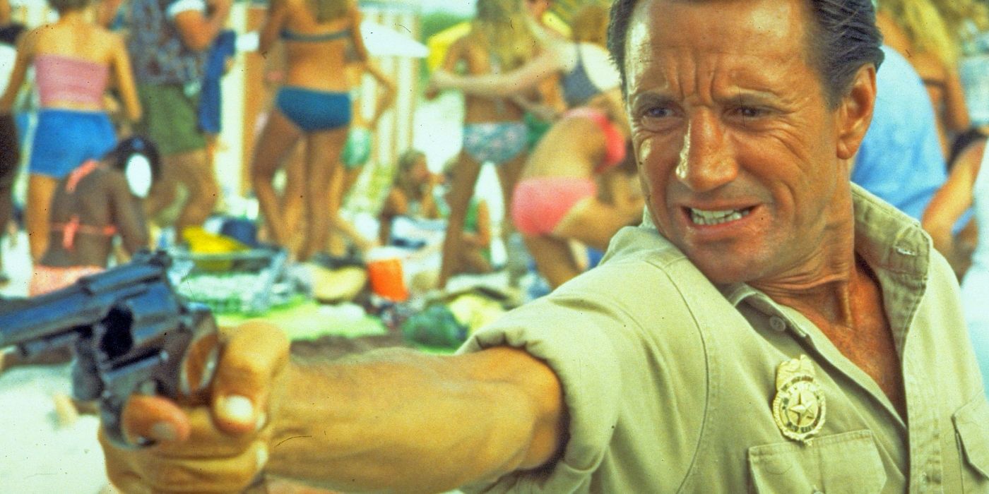 Roy Scheider as Martin Brody gripping a gun in Jaws 2
