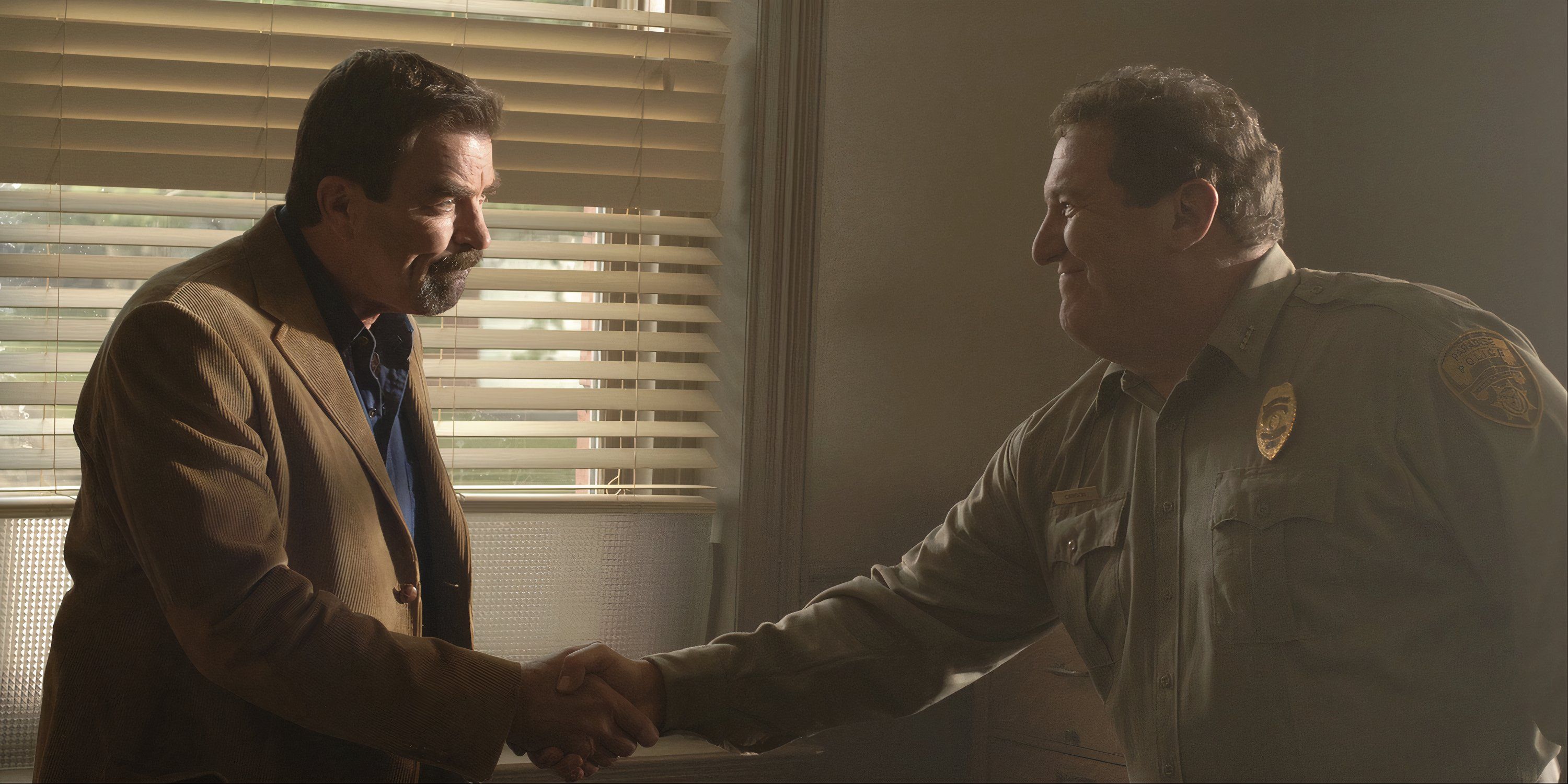 Jesse Stone (Tom Selleck) shakes hands with a law officer in 'Jesse Stone: Night Passage.'