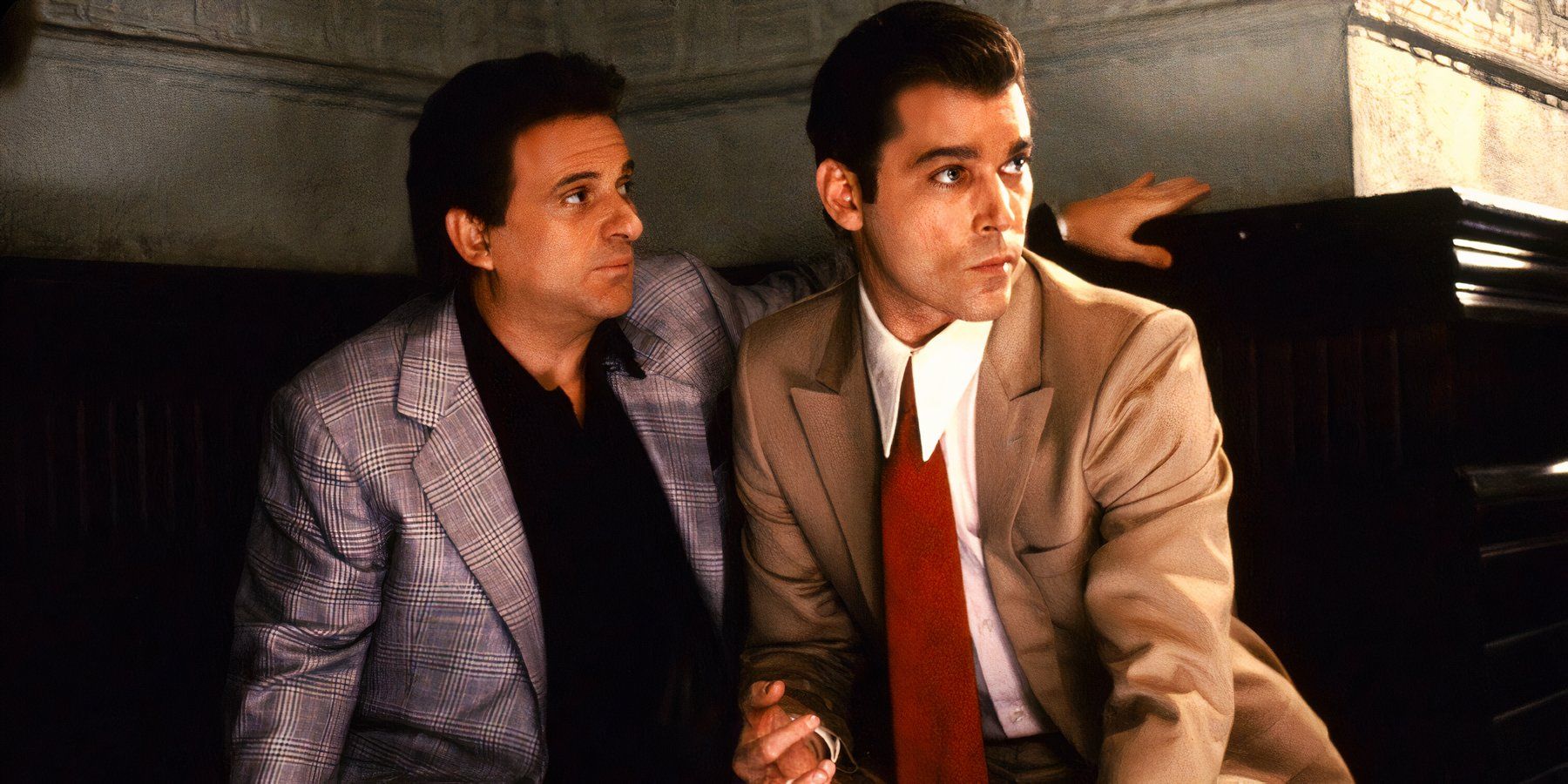 Tommy DeVito and Henry Hill keep an eye out for trouble while conducting shady business in GoodFellas.