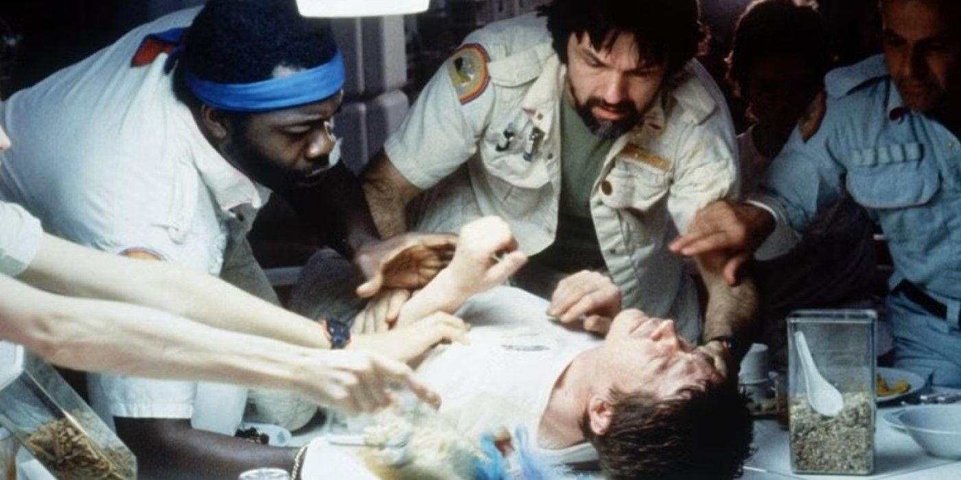Kane (John Hurt) is held down as he writhes on a table in 'Alien'