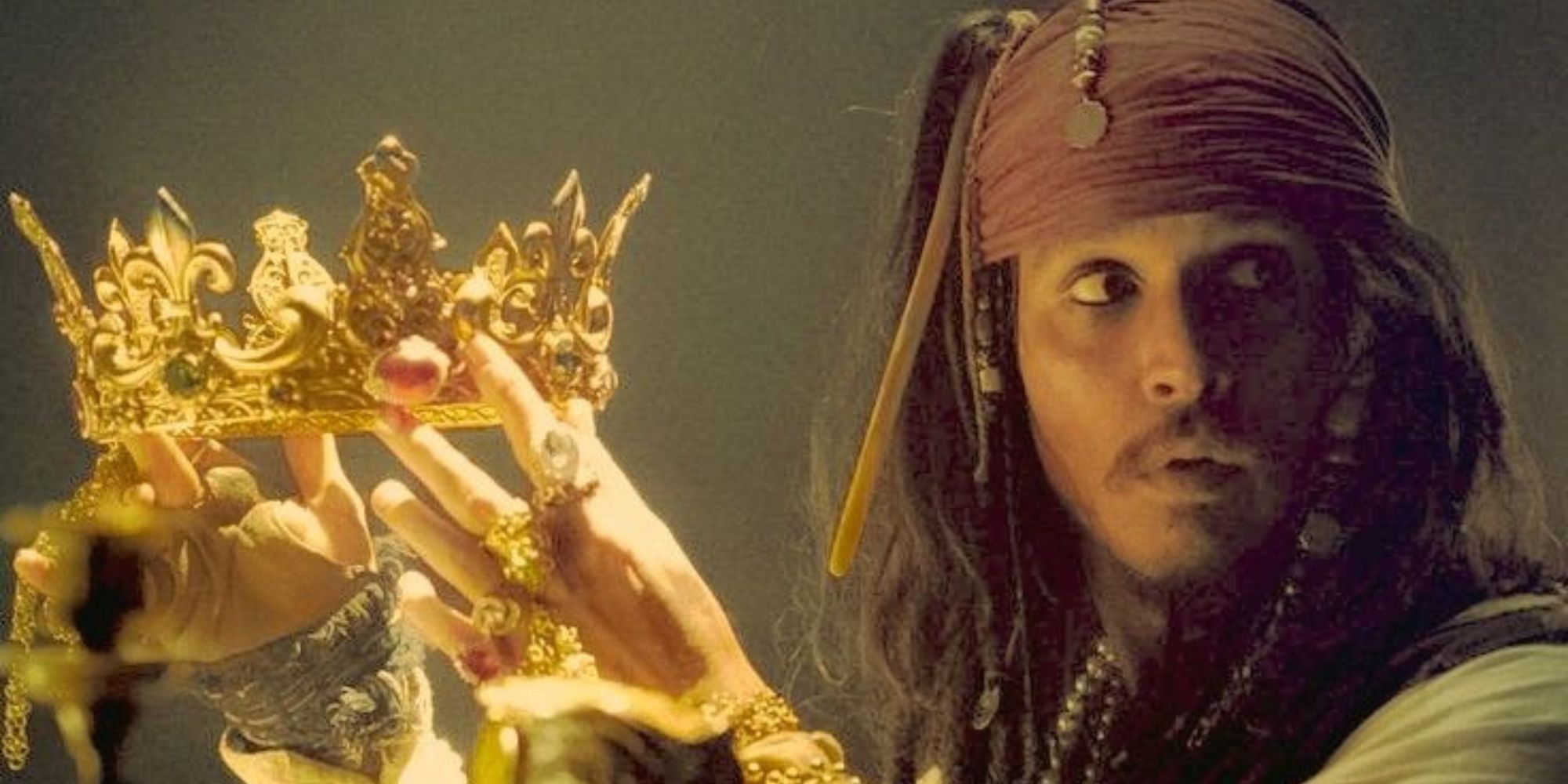 Jack Sparrow holding a gold crown in Pirates of the Caribbean The Curse of the Black Pearl