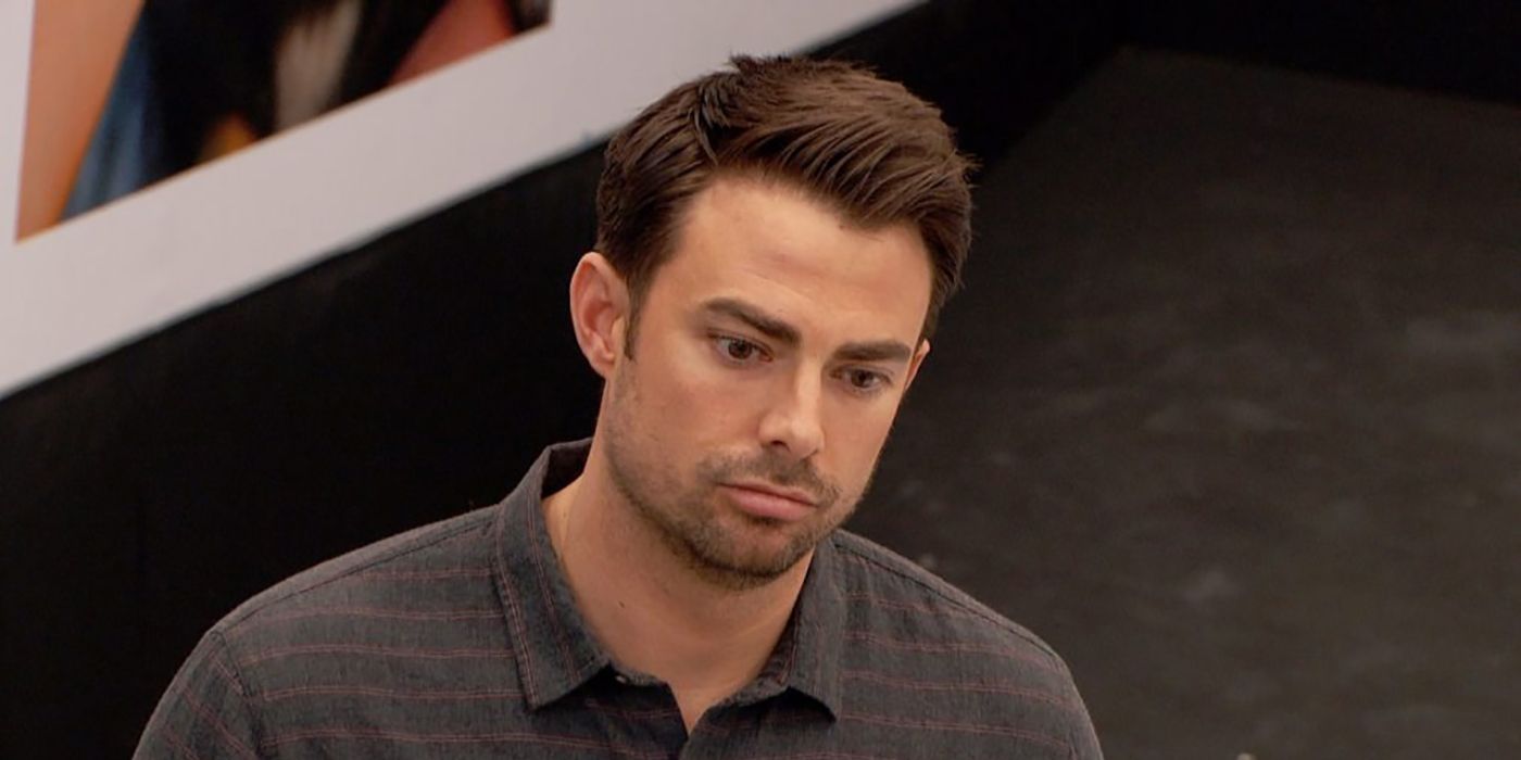 Jonathan Bennett looking down, upset with his eyes wide in a scene from Celebrity Big Brother.