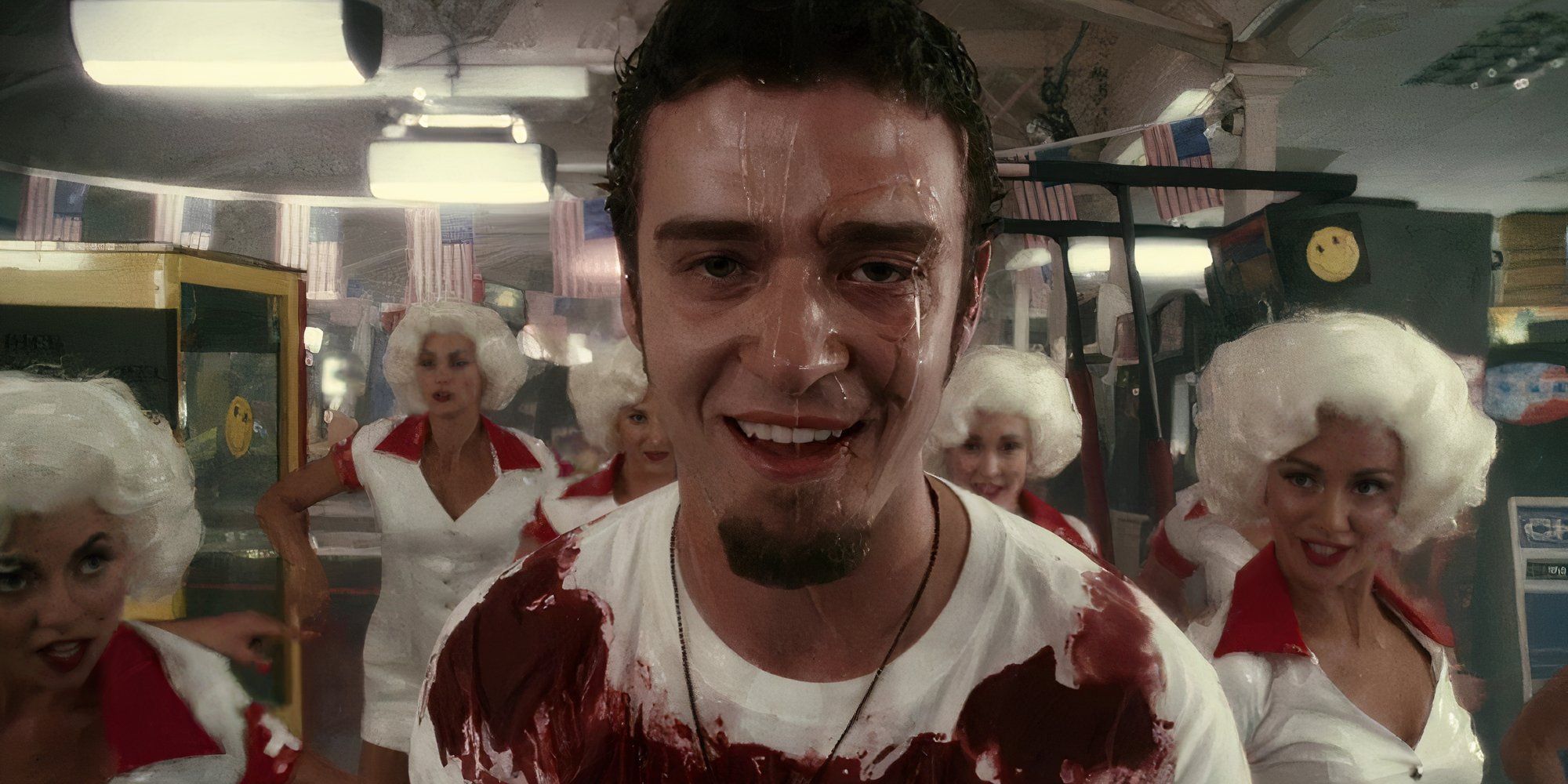 Justin Timberlake in Southland Tales with water running down his face and backup dancers