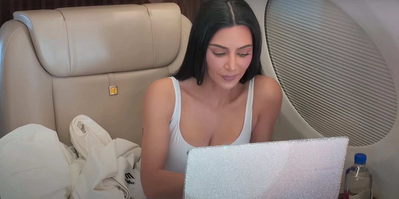 Kim Kardashian wearing a white tank top and facing a laptop in The Kardashians Season 5