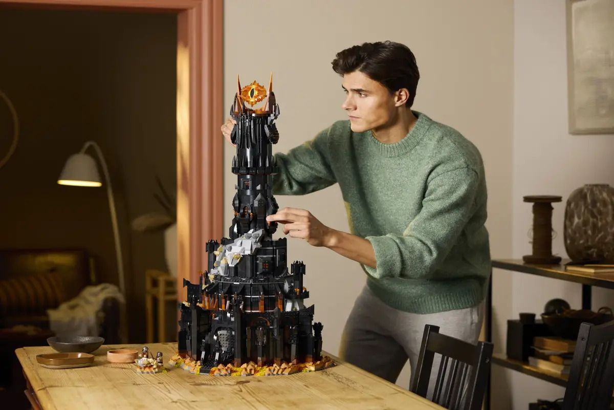 A man builds the Lego Lord of the Rings Barad-dur set.