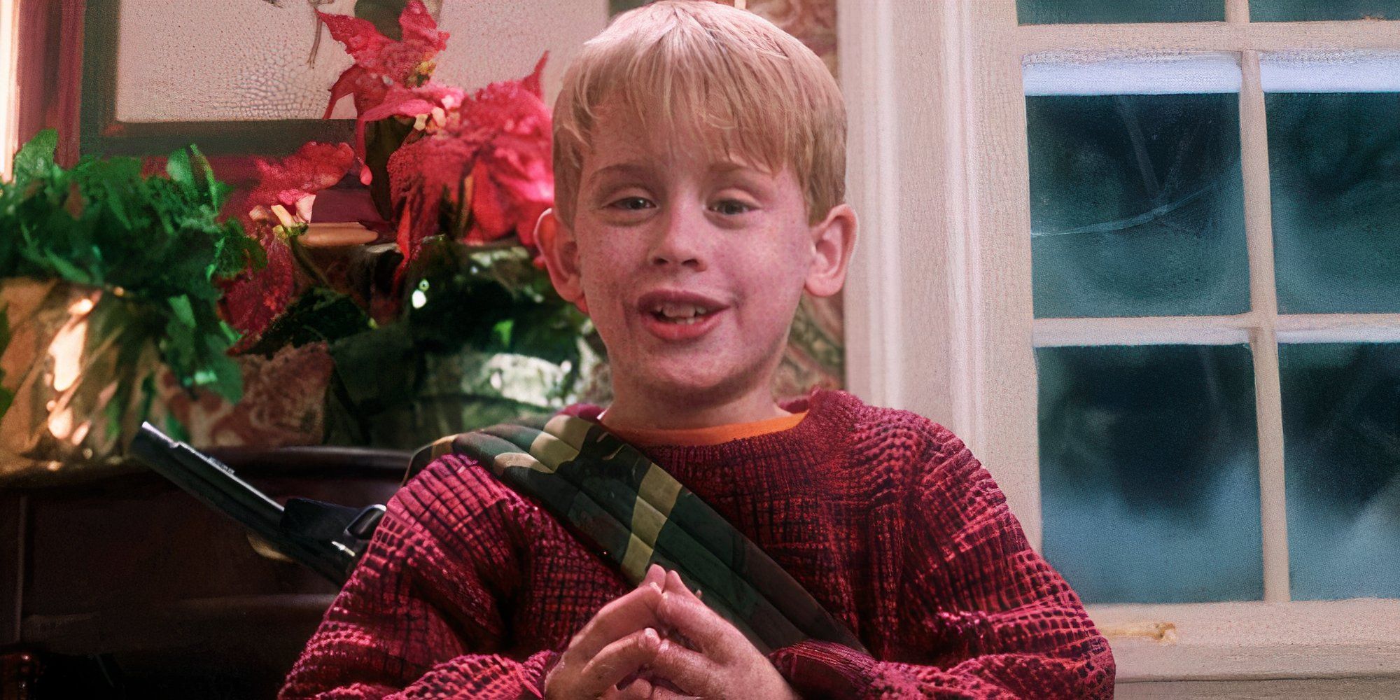 Macaulay Culkin as Kevin McCallister sitting at the top of the stairs in Home Alone (1990)