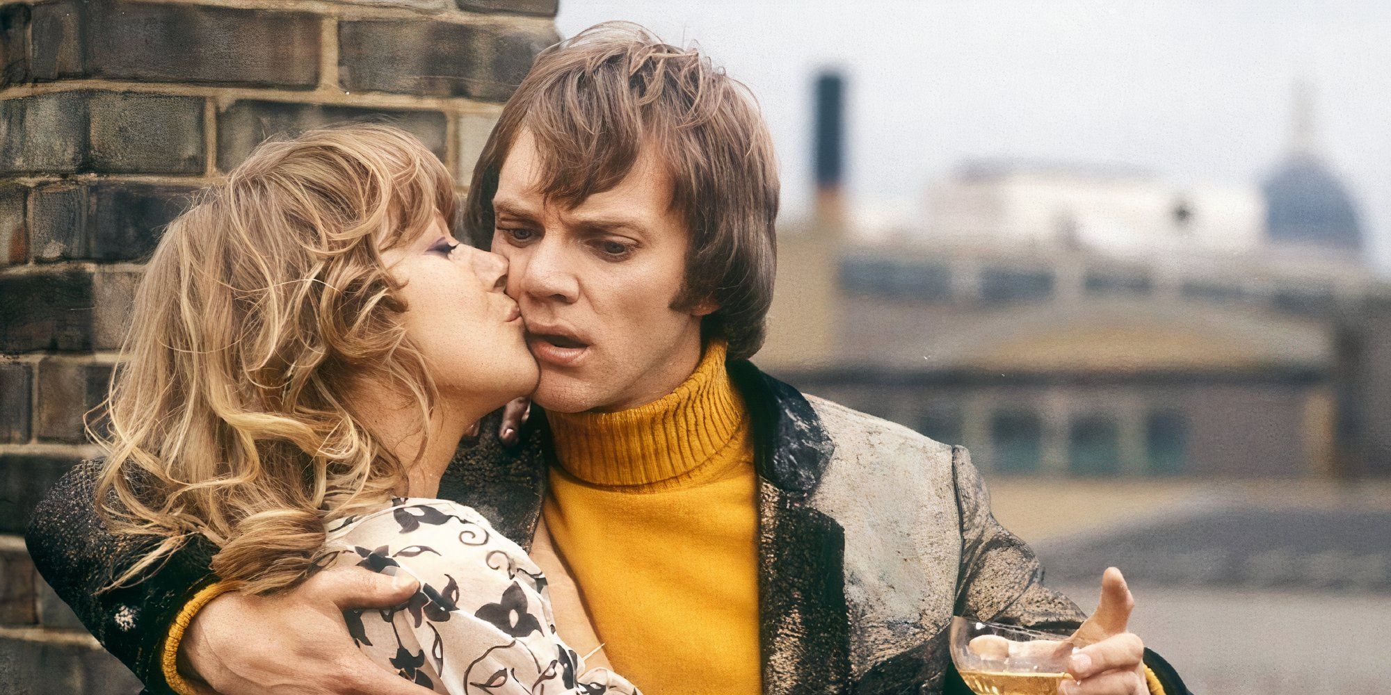 Helen Mirren as Patricia kissing Malcolm McDowell as Michael on the cheek in O Lucky Man!