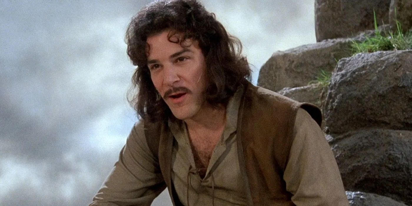 Inigo Montoya (Mandy Patinkin) sitting on a rock and talking to a person offscreen in The Princess Bride