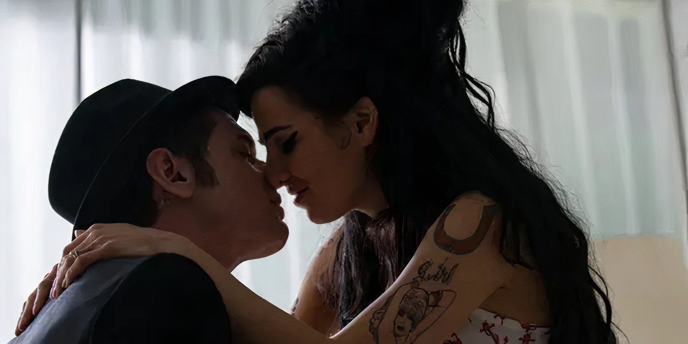 Jack O'Connell leaning to kiss Marisa Abela in a close up of them playing Blake Fielder-Civil and Amy Winehouse